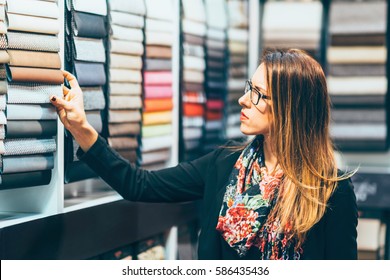 Designer looking fabric swatches on fair