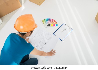 Designer looking at plan of the building before work