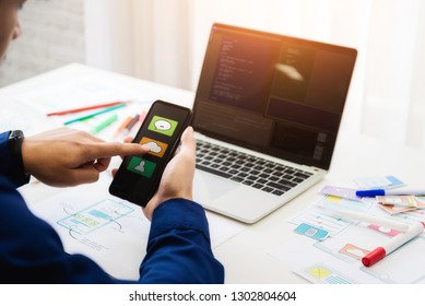 Designer Man Mobile Application Test New App Features. He Working With Computer And Mobile Phone. User Experience Design Concept.