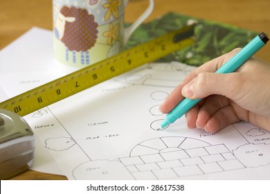 Designer Putting Together A Simple Garden Plan