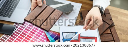 Designer with samples of materials at work table