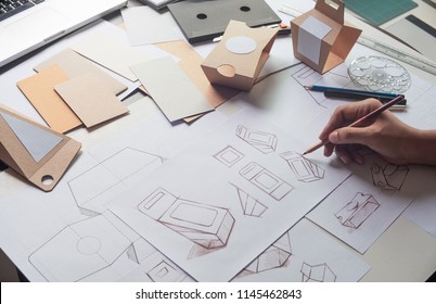 Designer Sketching Drawing Design Brown Craft Cardboard Paper Product Eco Packaging Mockup Box Development Template Package Branding Label . Designer Studio Concept .