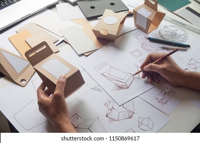 Designer sketching drawing design Brown craft cardboard paper product eco packaging mockup box development template package branding Label . designer studio concept . - Shutterstock ID 1150869617