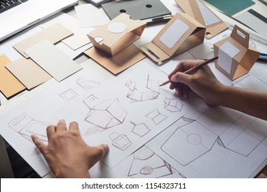 Designer sketching drawing design Brown craft cardboard paper product eco packaging mockup box development template package branding Label . designer studio concept . - Shutterstock ID 1154323711