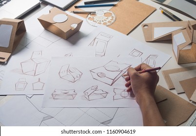 Designer Sketching Drawing Design Brown Craft Cardboard Paper Product Eco Packaging Mockup Box Development Template Package Branding Label . Designer Studio Concept .