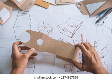 Designer Sketching Drawing Design Brown Craft Cardboard Paper Product Eco Packaging Mockup Box Development Template Package Branding Label . Designer Studio Concept .