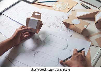 Designer sketching drawing design Brown craft cardboard paper product eco packaging mockup box development template package branding Label . designer studio concept . - Shutterstock ID 1185330376
