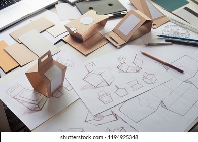Designer sketching drawing design Brown craft cardboard paper product eco packaging mockup box development template package branding Label . designer studio concept . - Shutterstock ID 1194925348