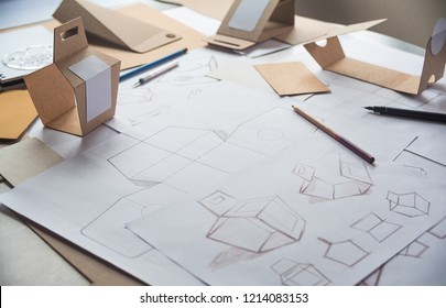 Designer sketching drawing design Brown craft cardboard paper product eco packaging mockup box development template package branding Label . designer studio concept . - Shutterstock ID 1214083153