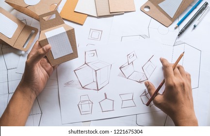 Designer Sketching Drawing Design Brown Craft Cardboard Paper Product Eco Packaging Mockup Box Development Template Package Branding Label . Designer Studio Concept .