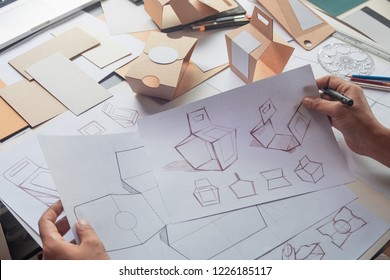 Designer sketching drawing design Brown craft cardboard paper product eco packaging mockup box development template package branding Label . designer studio concept . - Shutterstock ID 1226185117