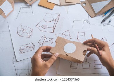 Designer Sketching Drawing Design Brown Craft Cardboard Paper Product Eco Packaging Mockup Box Development Template Package Branding Label . Designer Studio Concept .