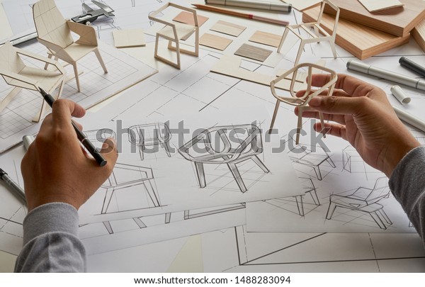 Designer sketching drawing design development product\
plan draft chair armchair Wingback  Interior furniture prototype\
manufacturing production. designer studio concept .                \
          