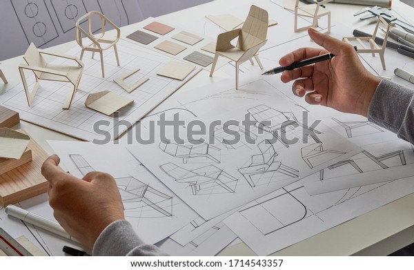 Designer sketching drawing design development product\
plan draft chair armchair Wingback Interior furniture prototype\
manufacturing production. designer studio concept .                \
          