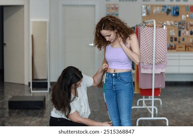 Designer taking precise body measurements of a client in a fashion studio for custom garment fitting. Tailor and retail concept - Powered by Shutterstock