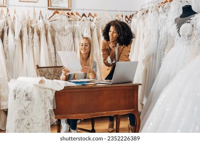 Designer talks to a bride about her wedding dress design. - Powered by Shutterstock