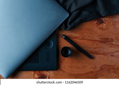 Designer using graphic tablet in the office. Top view workplace with tablet, keyboard and computer. photography desk . laptop and tablet . photography workspace . office desk top view 