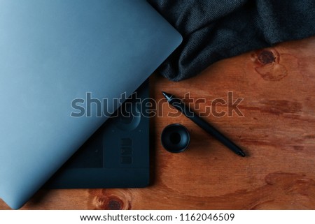 Designer using graphic tablet in the office. Top view workplace with tablet, keyboard and computer. photography desk . laptop and tablet . photography workspace . office desk top view 
