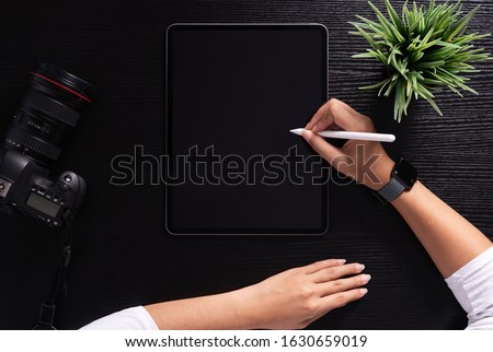 designer using stylus pen on top view