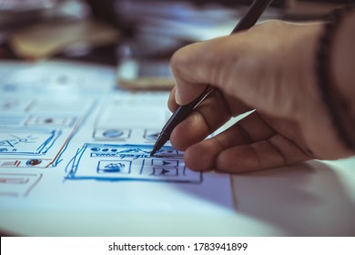 Designer web development team website template design for user ui application on paper or framework layout for pre-production. Web developments is creative involved in developing wireframe for apps