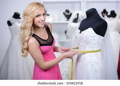 Designer Wedding Dresses, Measures The Dress On A Mannequin In Her Shop