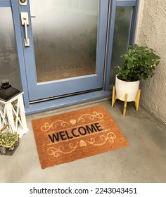 Designer Welcome Entry Doormat Placed on Solid Brick Floor Outside Entry Door with Plants - Shutterstock ID 2243043451