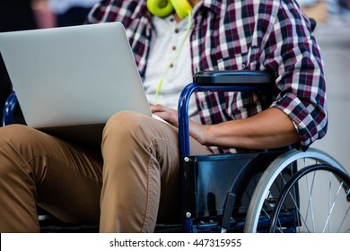 Designer In A Wheelchair With A Computer In The Office