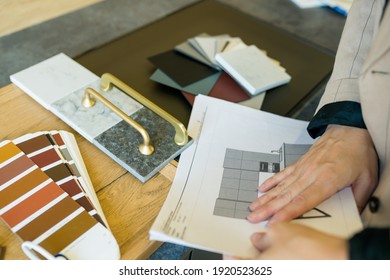 Designer Woman Choosing Details Of New Kitchen In A Home Improvement Store. Real Estate, Home Renovation, Small Business Concept