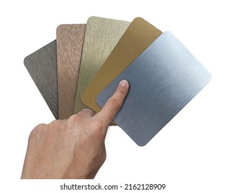 designer's hand choosing brushed metallic laminated samples containing  silver ,gold ,rose gold ,nigel and copper texture. set of multi color and texture of aluminum samples isolated on background. - Shutterstock ID 2162128909