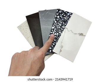 Designer's Hand Choosing Quartz Samples Swatch Isolated On Background With Clipping Path. Multi Color And Pattern Of Artificial Stones For Kitchen Counter Top With Precise Processed Edges.