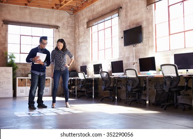 Designers Planning Layout On Floor Of Modern Office