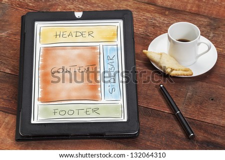 designing website layout on digital tablet computer with a cup of coffee, cookie and stylus pen