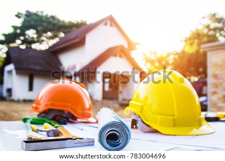 Desk of Architectural working project in construction site,With drawing equipmen