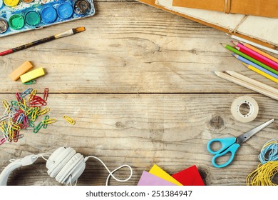 Desk of an artist with lots of stationery objects. Studio shot on wooden background. - Shutterstock ID 251384947
