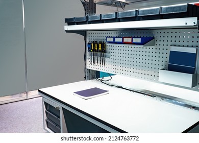 Desk Of Auto Mechanic. Car Repair Desk. Workplace Is Master Repairman. Screwdrivers Attached To Metal Surface. Concept Of Equipment For Car Workshop. Work Surface With Magazine In Auto Repair Shop