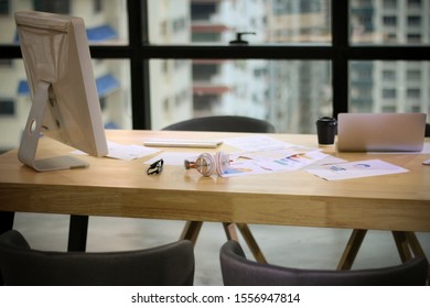 desk of business designer or freelance in office with desktop computer and stationary, furniture interior