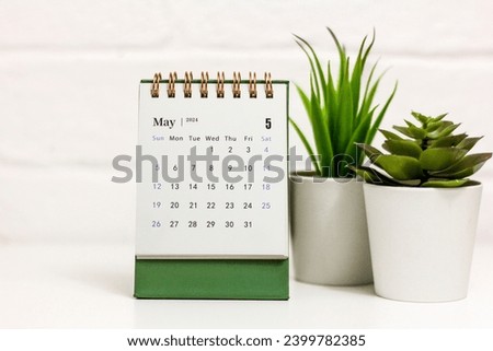 Desk calendar for May 2024 on a green background