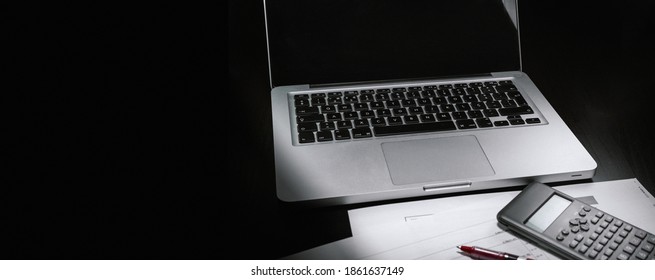 Desk With Copy Space On Image, Economic Scenario, Accounting Material . Computer And Calculator And Red Pen With Economic Reports.