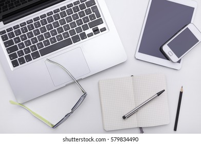 Desk with different office objects on it