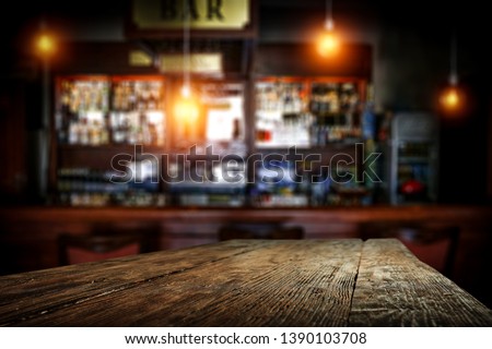 Desk of free space for your decoration and blurred background of bar. 
