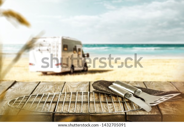 Desk of free space\
for your decoration and summer grill time on beach. Sea landscape\
with sky and sumer car. 