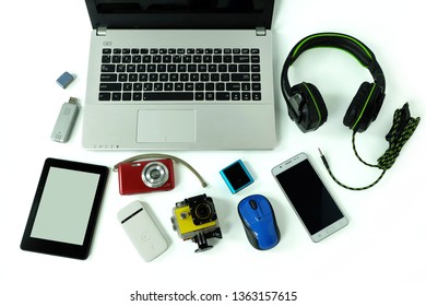 Desk with gadgets or electronic equipment for daily use, laptop computer, cell phones and digital camera isolated on white background - Shutterstock ID 1363157615
