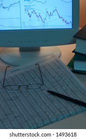 desk with glasses for stock analysis - Shutterstock ID 1493618
