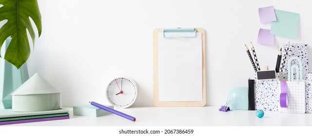 Desk In Kids Room With Frame Mock Up, Clock, Books, Notes On The Wall And Many Purple Supplies.
