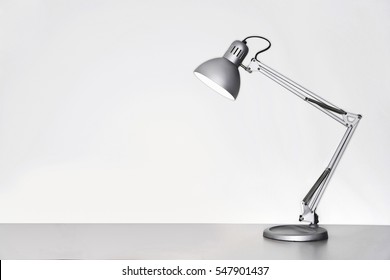 Desk Lamp On Table Over White Background