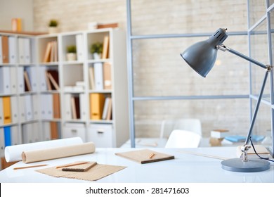 Desk With Lamp, Papers And Pencils In Office