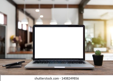 Desk Laptop With Blank Screen On Table Of Coffee Shop Blur Background With Bokeh