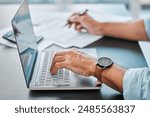 Desk, laptop and hands with paperwork in office for bookkeeping, payroll or monthly profit. Finance, administration and business person with computer for accounting, tax audit or planning budget