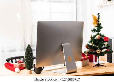 Desk Office Or Workplace With Modern Computer And Christmas Gift Box Decoration.