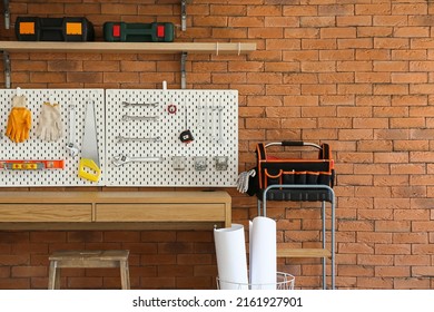 Desk and pegboard with tools in carpentry workshop - Shutterstock ID 2161927901